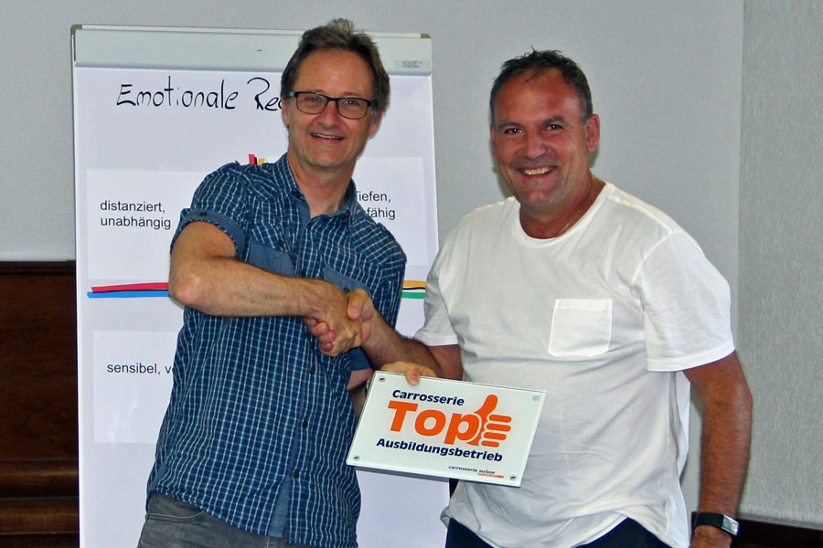 Geschafft: Philip Kyriakidis (rechts) erhält von VSCI-Geschäftsführer Thomas Rentsch die Plakette «Top-Ausbildungsbetrieb».