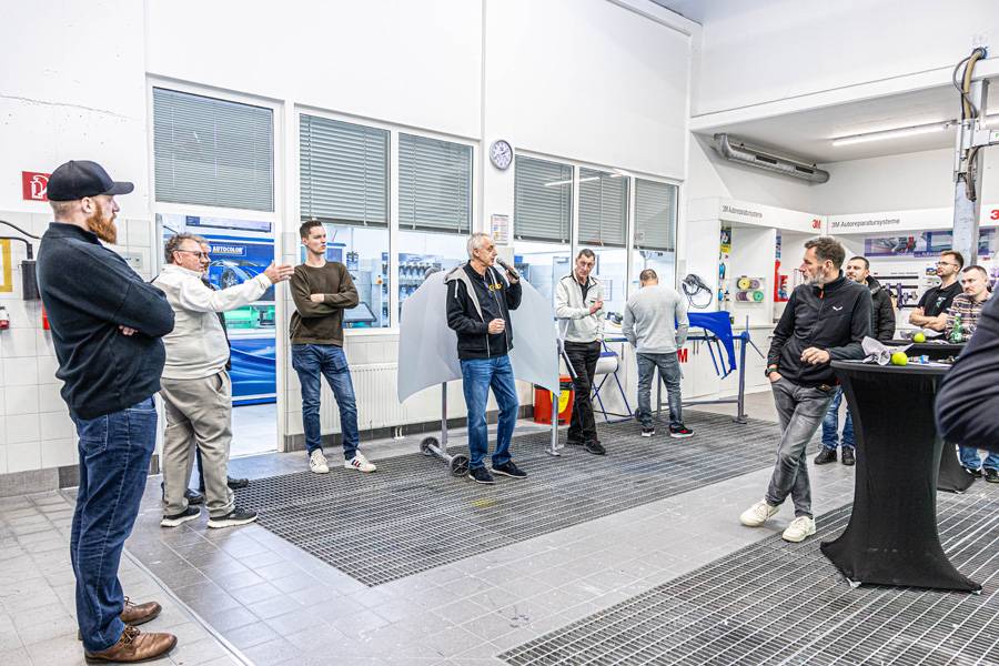 Questions et réponses : pendant que le robot de peinture accomplit son travail dans la cabine avec un calme stoïque, Roger Blum répond avec compétence aux interrogations sur son produit.