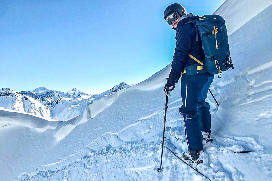 David Bühlmann en sortie à ski – là où les pentes sont plus silencieuses que n’importe quelle radio d’atelier. Un bref regard en arrière, devant lui un long ruban de trace fraîche, et au-dessus cette arête neigeuse, taillée comme au scalpel dans la lumière du matin.