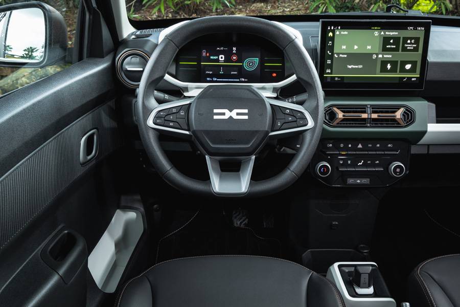 Un coup d’œil sur la place du conducteur : le combiné d’instruments numériques, l’écran tactile central et les commandes volontairement simplifiées illustrent une électrification fonctionnelle au format compact. 