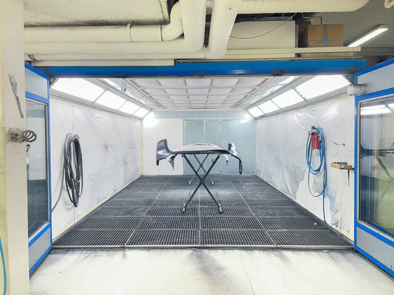 Bereit für den nächsten Arbeitsschritt: In der Lackierkabine warten vorbereitete Fahrzeugteile auf den Lackierer und ihren makellosen Auftritt.